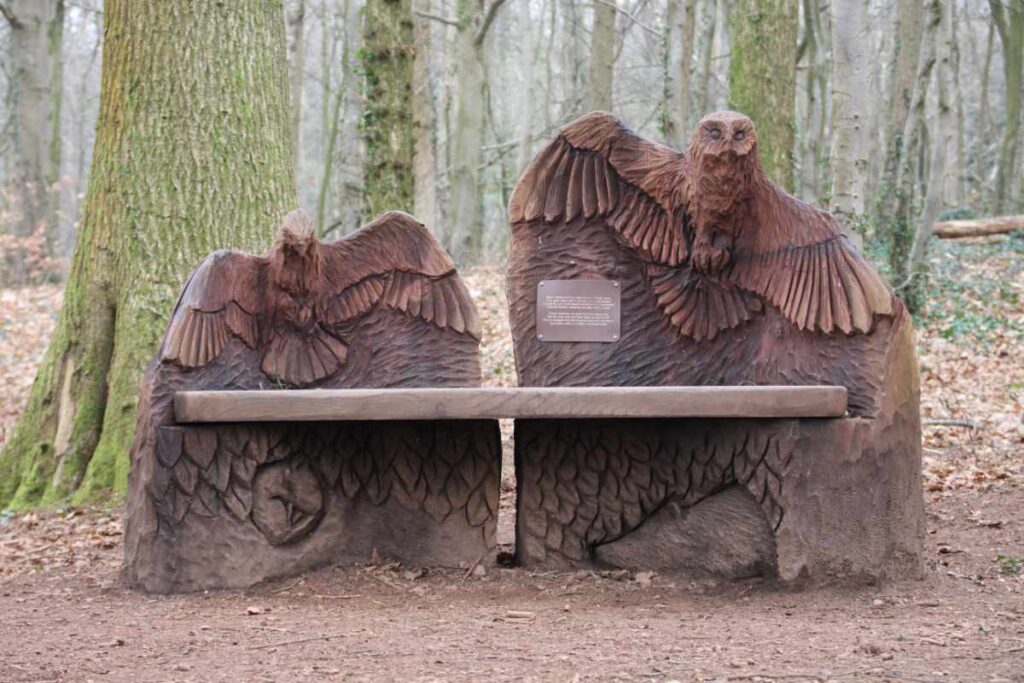 Wooden bench with bird sculptures