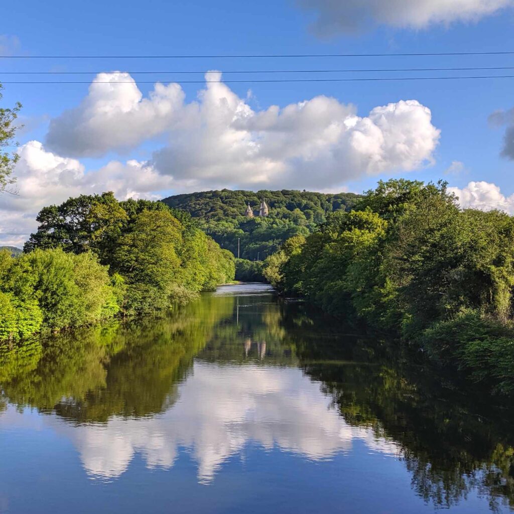 Castell Coch on the River Taff with large white clouds