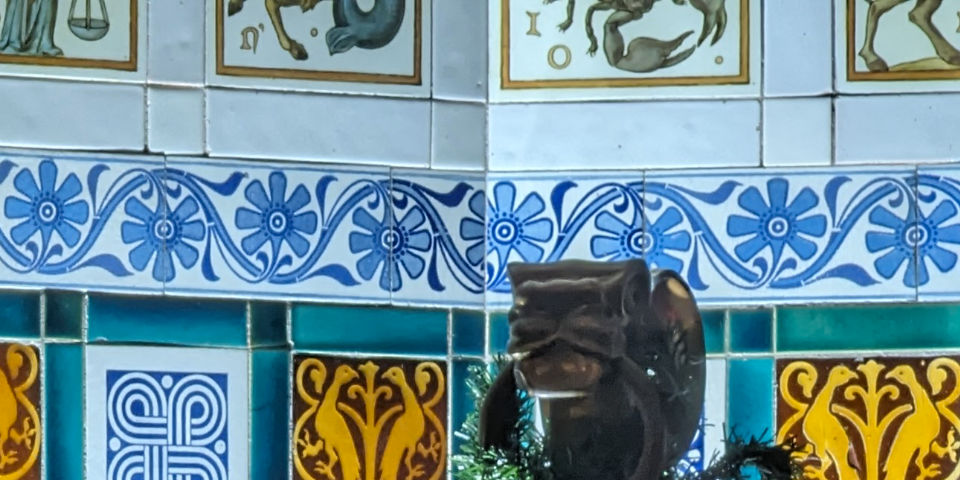 Close up detail of a tiled fireplace in Castell Coch