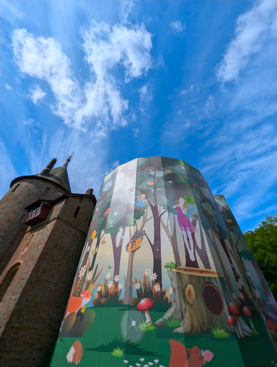 Looking up at Castell Coch, focussing on the colourful wrap on the Well Tower.
