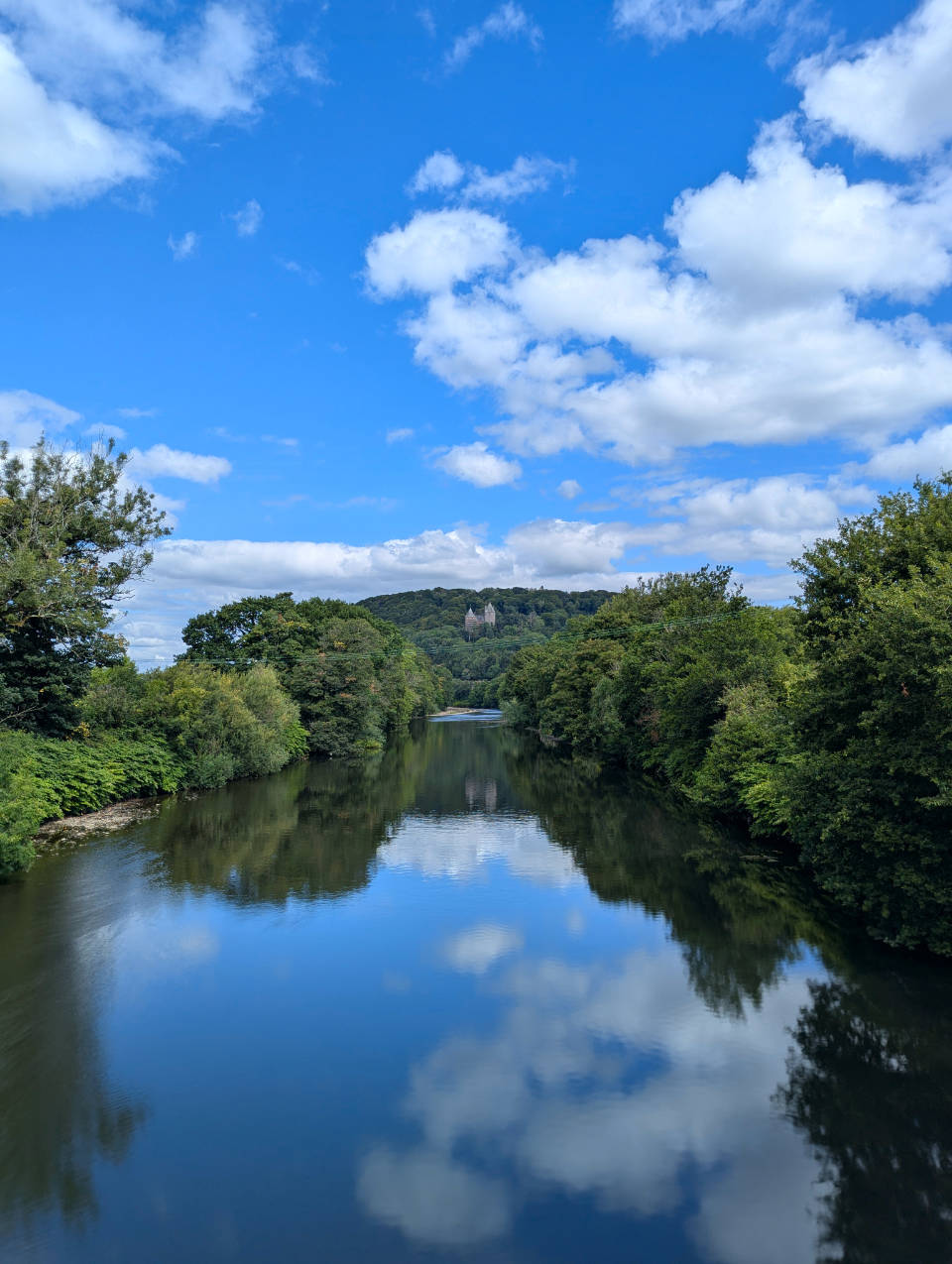 Castell Coch in Fforest Fawr reflected in the River Taff.